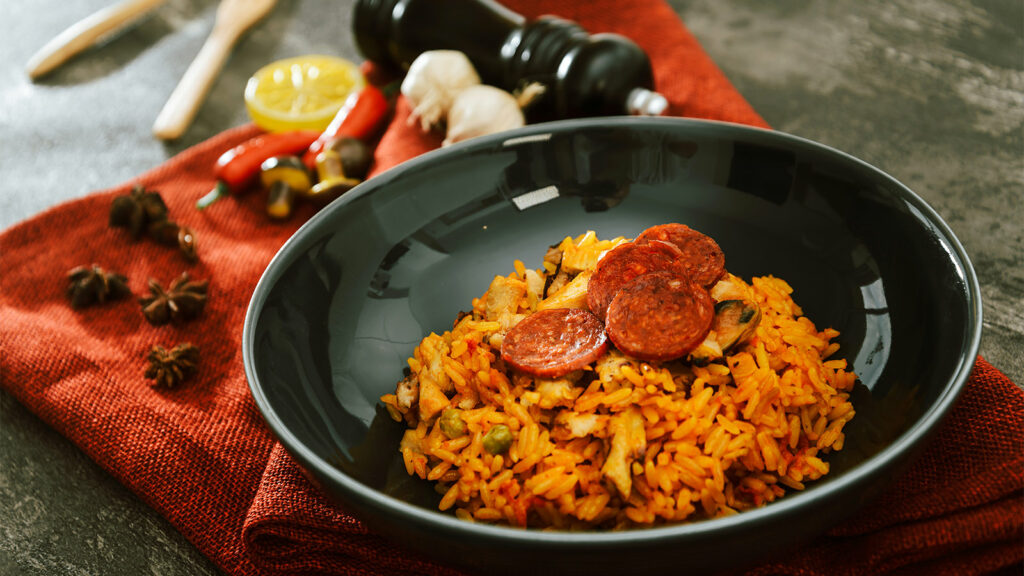 Dish of paella on table setting