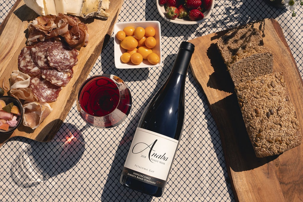A bottle of Anaba's Roberts Road Pinot Noir framed by snacks.