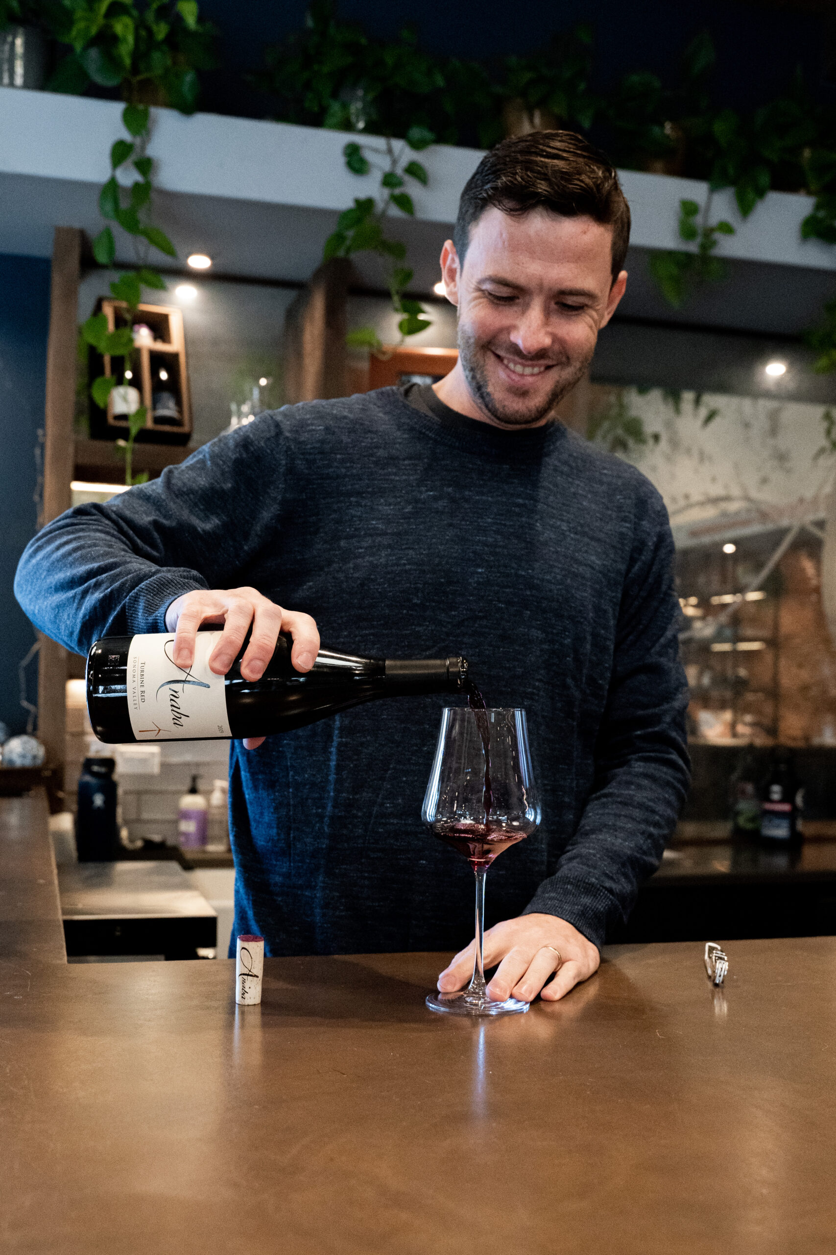 Wine Club Manager, Ben Curley pouring a glass of wine.