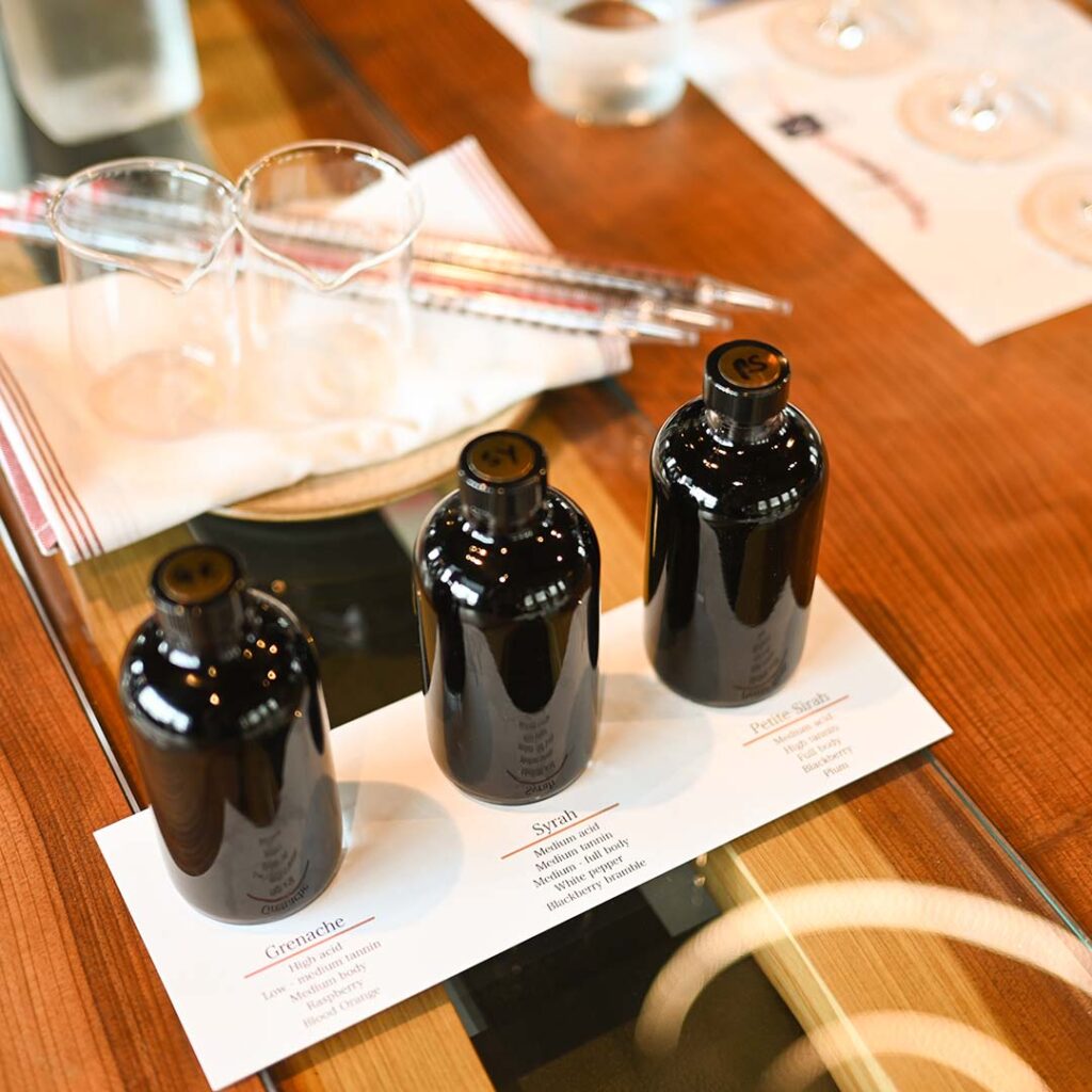 Three small bottles used in the process of blending wine. 