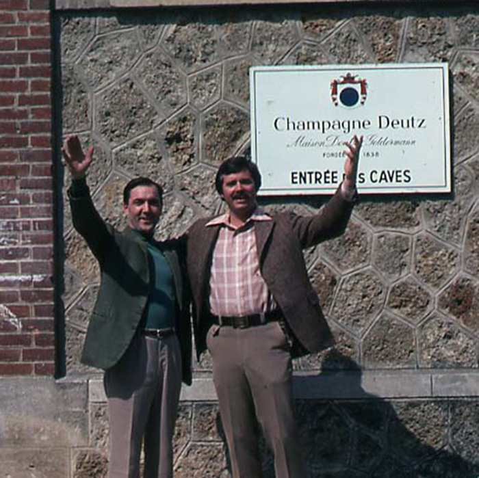 John in 1970's, standing in front of the sign at Champagne Deutz. 
