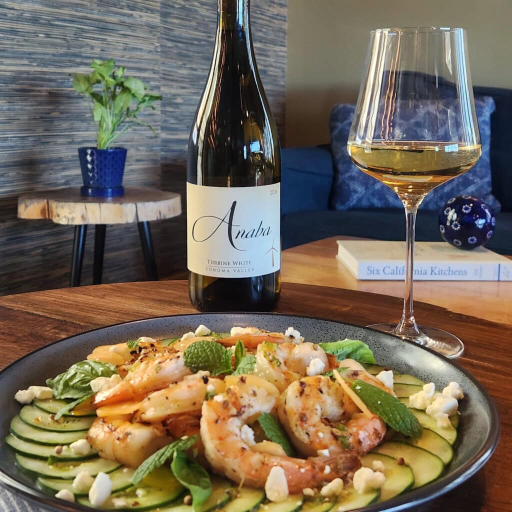 shrimp salad on a plate with cucumbers feta and melon with a bottle and glass of White Rhone wines